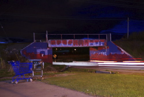 Cartoon: Night time trestle (medium) by Krinisty tagged train,trestle,nighttime,cars,trucks,driving,lights,roadway,bridge,scenic,shoppingcart,blue,colors,dark,art,photography,krinisty