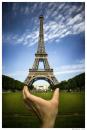 Cartoon: Let Me Feel Your Cosmos (small) by BenHeine tagged paris eiffel tower ben heine france hold tenir porter bring me to your heart spiritual connection monument capital ciel cosmos correspondances main doigts fingers afar terrain ground green search carry heavy fer fly nowhere peter quinn